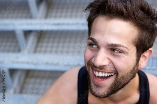 Happy young man with beard laughing