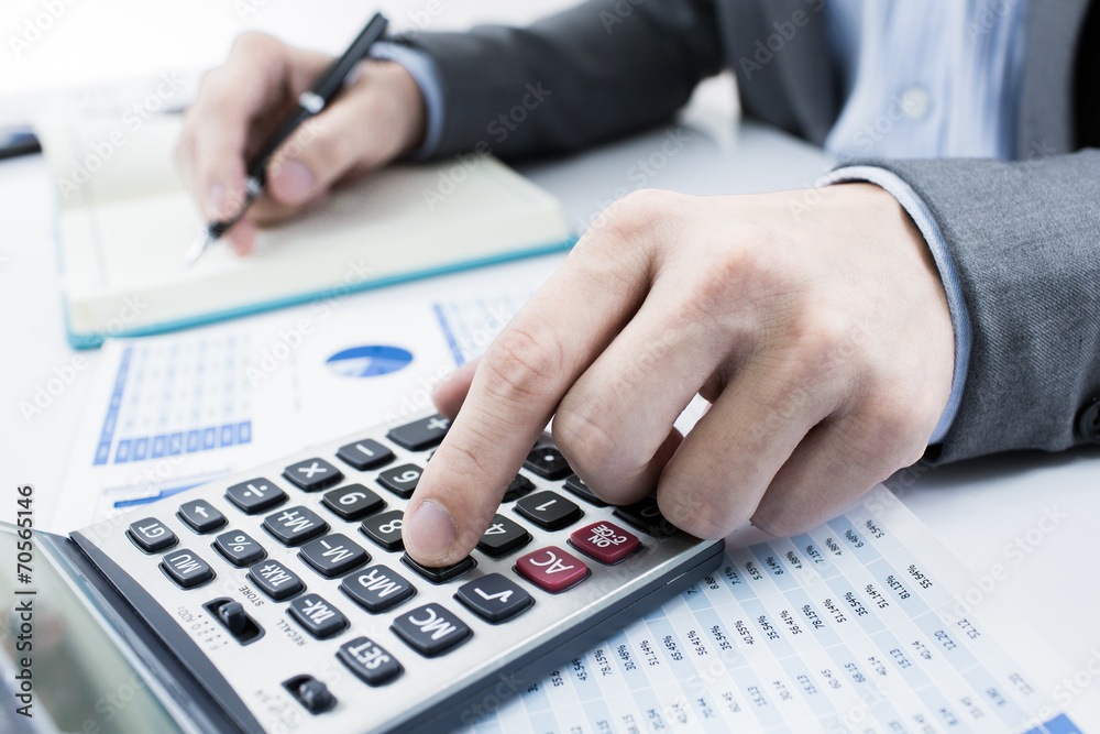 Businessman analyzing investment charts. Accounting