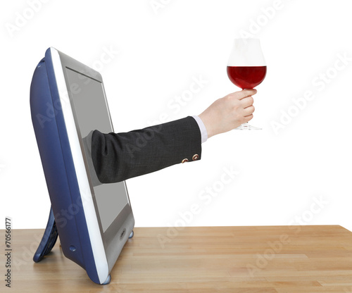 red wine glass in businessman hand leans out TV photo