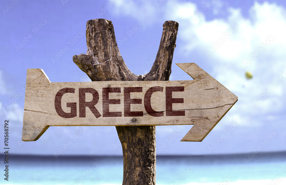 Greece wooden sign with a beach on background