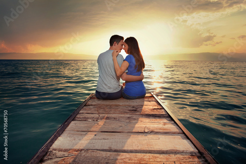 Young couple kissing at sunset