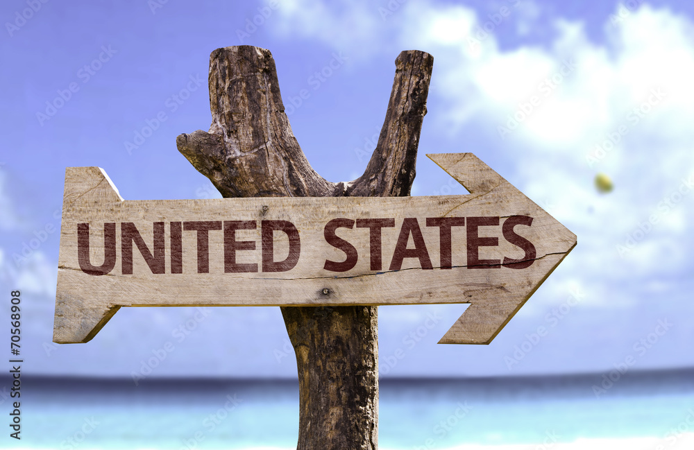 United States wooden sign with a beach on background
