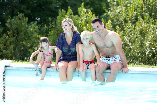 Family of four enjoying swimming time