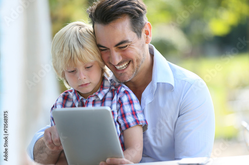 Wallpaper Mural Portrait of man with son using digital tablet Torontodigital.ca