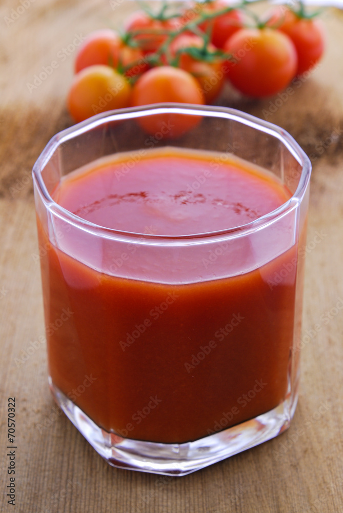 Tomato juice and cherry tomatoes on the vine Tomato juice and cherry tomatoes on the vine