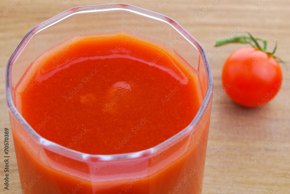 Tomato juice and cherry tomatoes on the vine Tomato juice and cherry tomatoes on the vine