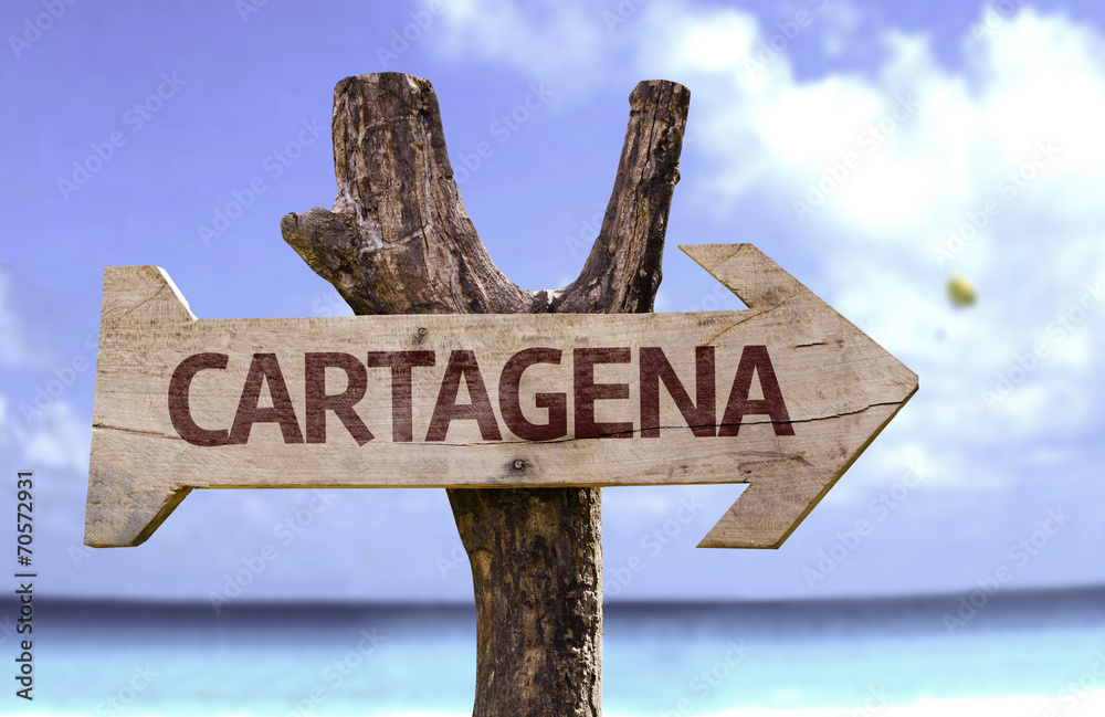 Cartagena wooden sign with a beach on background