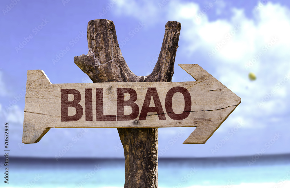 Bilbao wooden sign with a beach on background