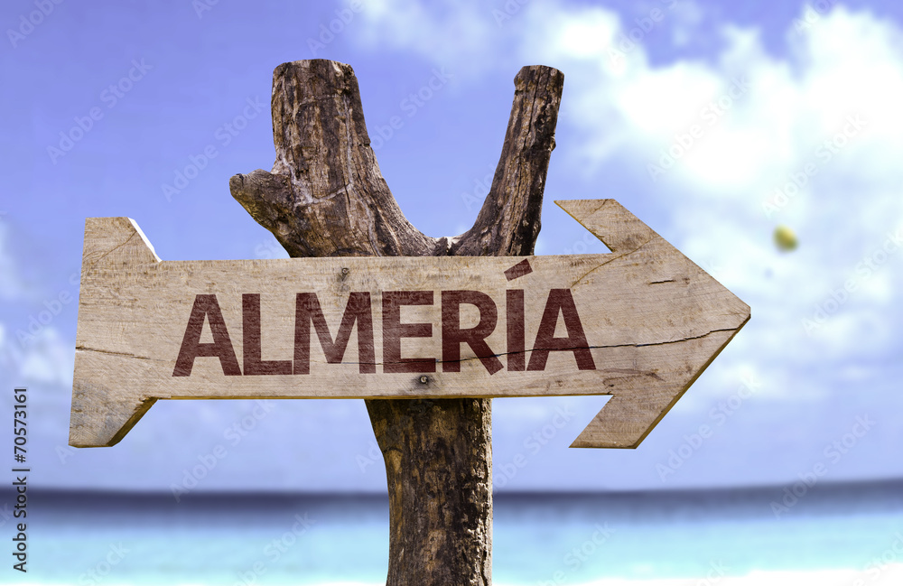 Almeria wooden sign with a beach on background