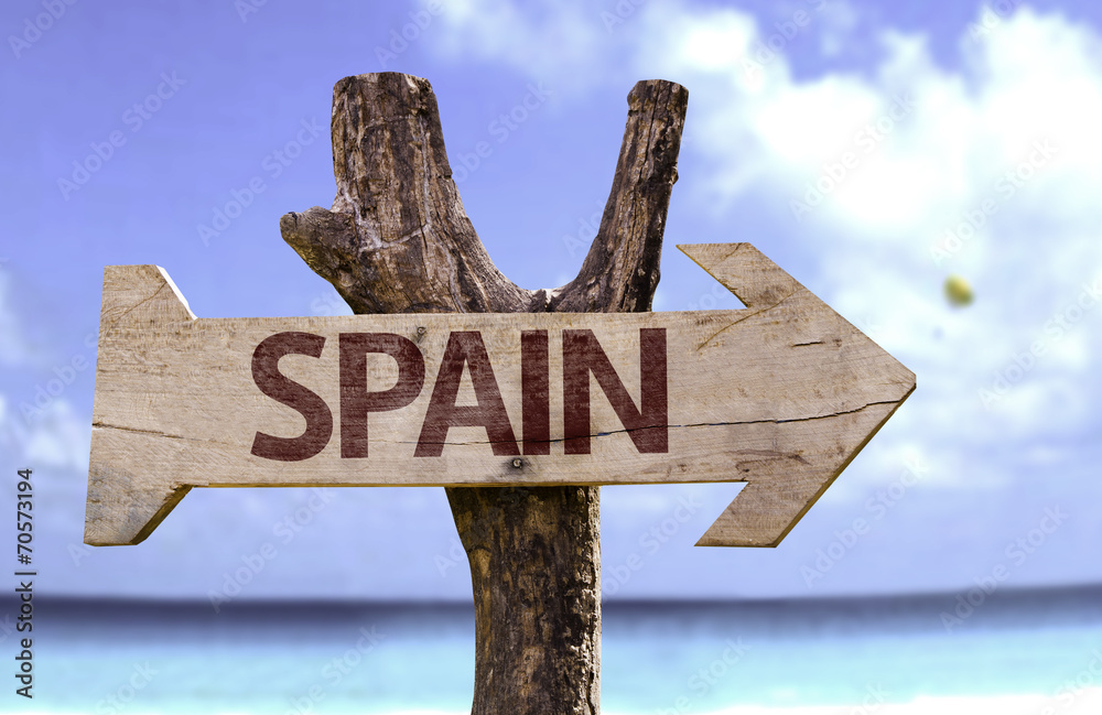 Spain wooden sign with a beach on background