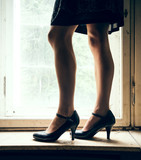 Woman legs in front of a window