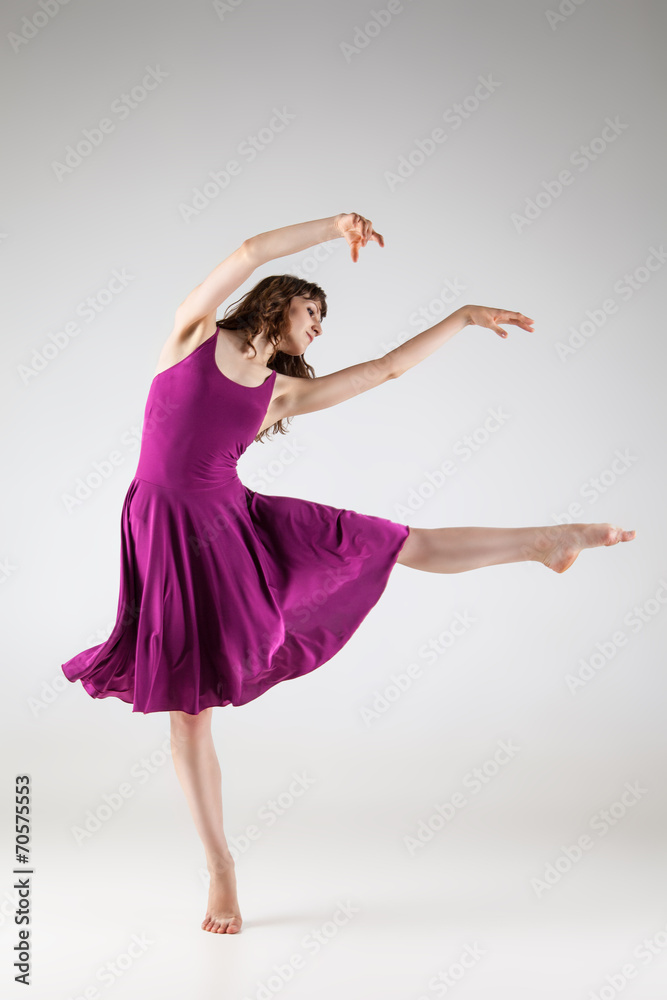 Young ballet dancer wearing purple dress over grey Young ballet dancer wearing purple dress over grey