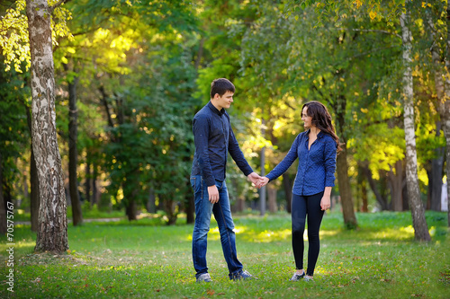 man and woman walking in the park