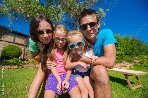 Portrait of beautiful family of four on tropical vacation