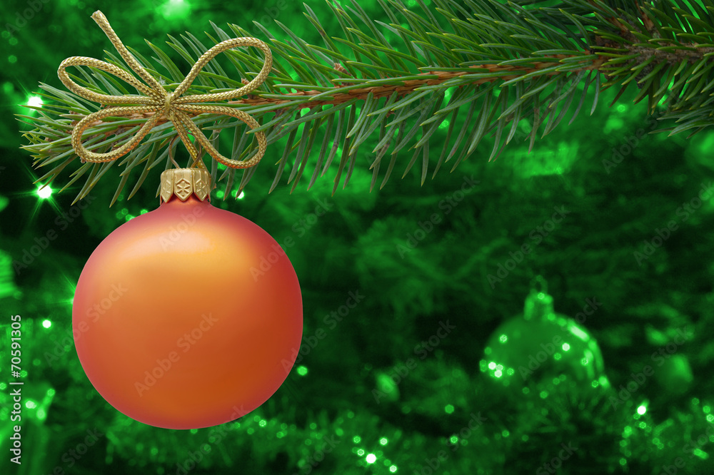 Naklejka premium Christmas bauble and spruce branch on green background