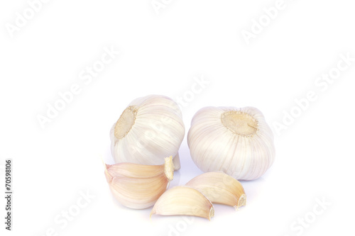 Garlic bulb and cloves on white background