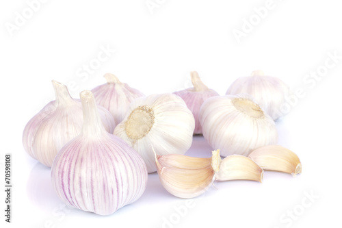 Garlic bulb and cloves on white background
