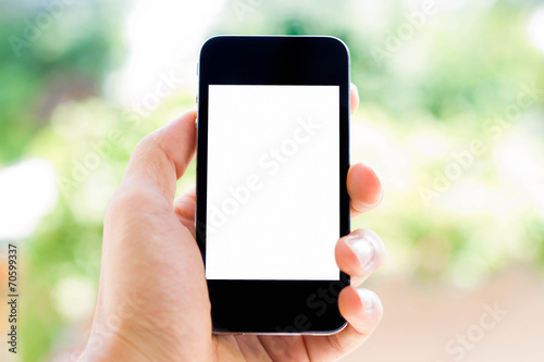 Close-up Hand holding smart phone with blurred nature background