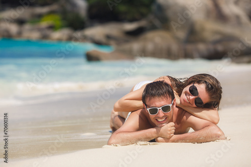 An attractive man and woman on the beach.