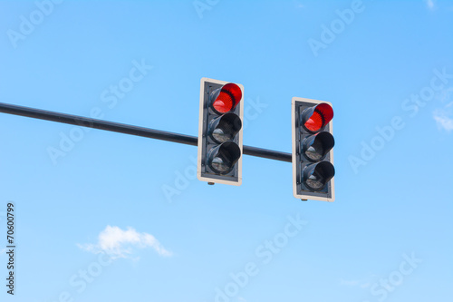 image of traffic light, the red light is lit. symbolic  for hold