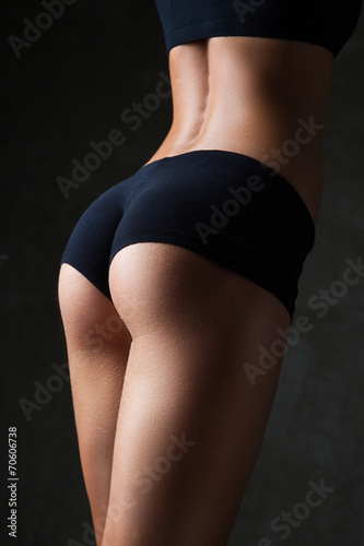 Beautiful fit, sexy female body on dark grey