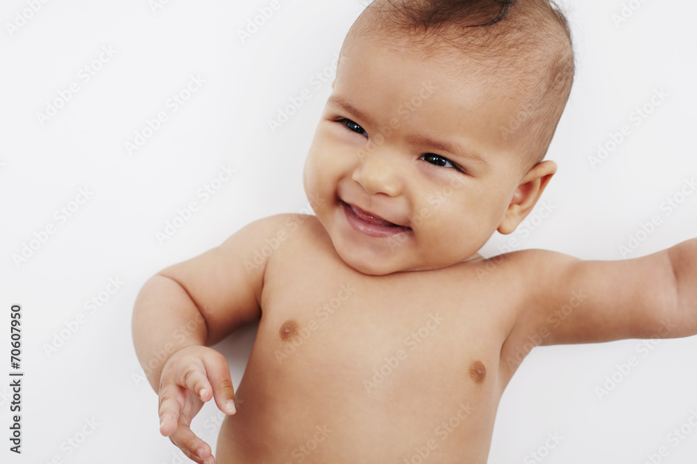 Cute six month old baby girl against white background. Cute six month old baby girl against white background.