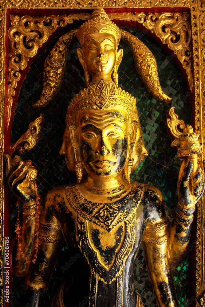 High contrast image of golden buddha sculptures on the temple en