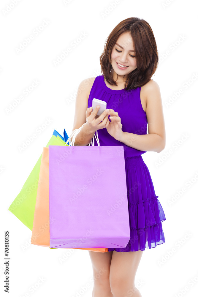 happy young woman holding shopping bags and mobile phone happy young woman holding shopping bags and mobile phone