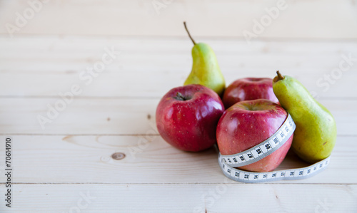pear and apple  on the wooden background, shape of the body