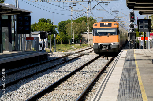 Modern orange train on station. Barcelona, Spain.