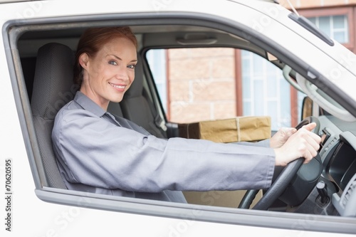 Delivery driver smiling at camera in her van © WavebreakMediaMicro