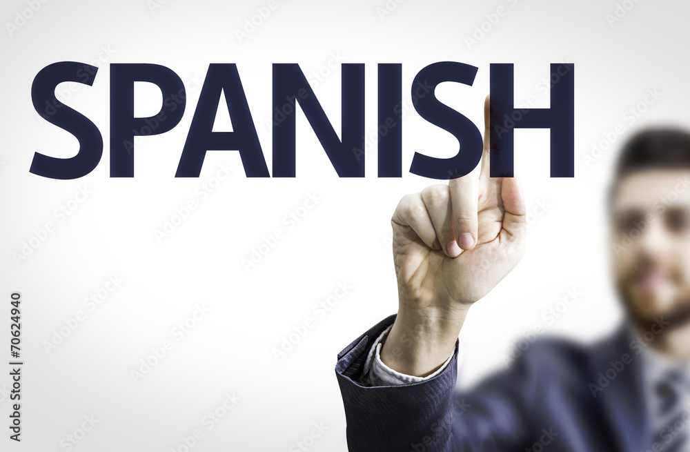 Business man pointing to transparent board with text: Spanish Business man pointing to transparent board with text: Spanish