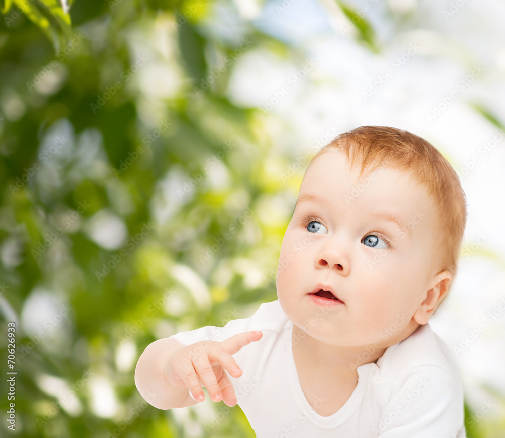 curious baby lying on floor and looking side curious baby lying on floor and looking side
