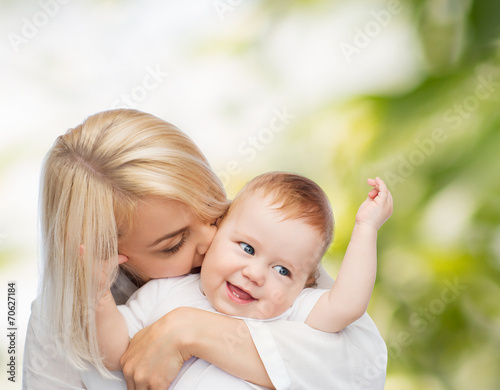happy mother kissing smiling baby