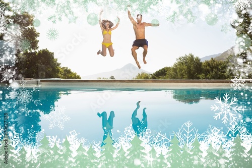 Cheerful couple jumping into swimming pool