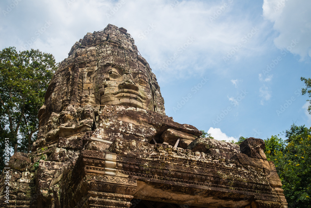 Bayon face on the gate of Angkor Thom the world heritage ancient Khmer city of Siem Reap, Cambodia.