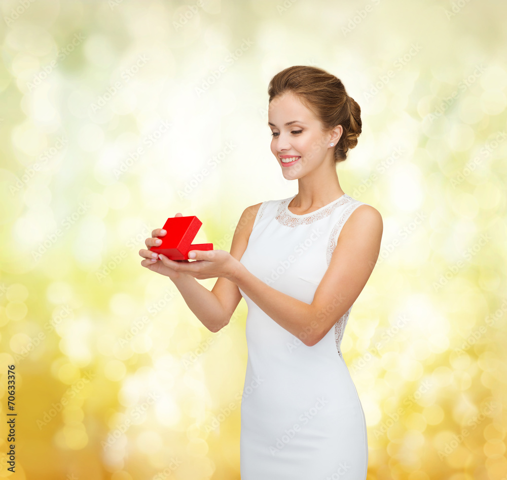 smiling woman holding red gift box