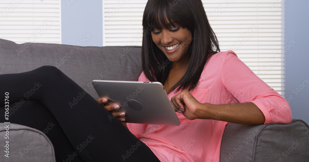 Black woman using pad in pink shirt