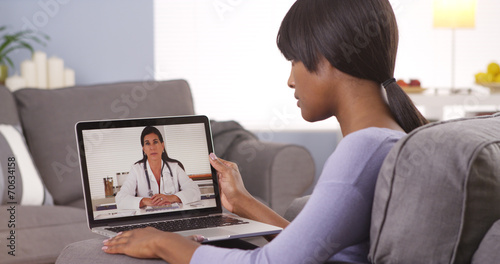 African woman video chatting with doctor © rocketclips