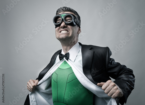 Fotografie Superhero taking off shirt and jacket