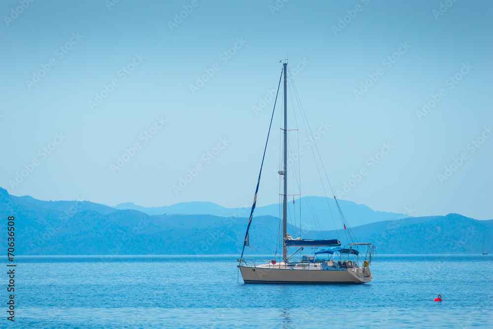 lone sailing yacht drifting in the sea