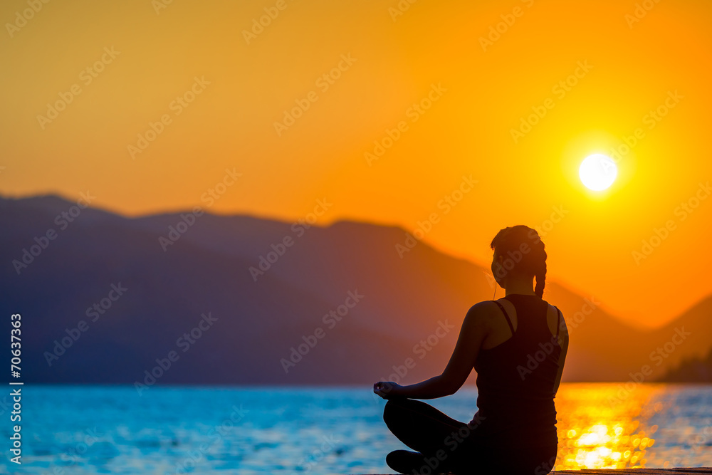 athlete on the background of mountains and rising sun relaxes