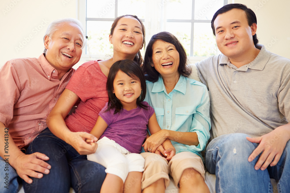 Multi Generation Family Sitting On Sofa At Home Together Multi Generation Family Sitting On Sofa At Home Together