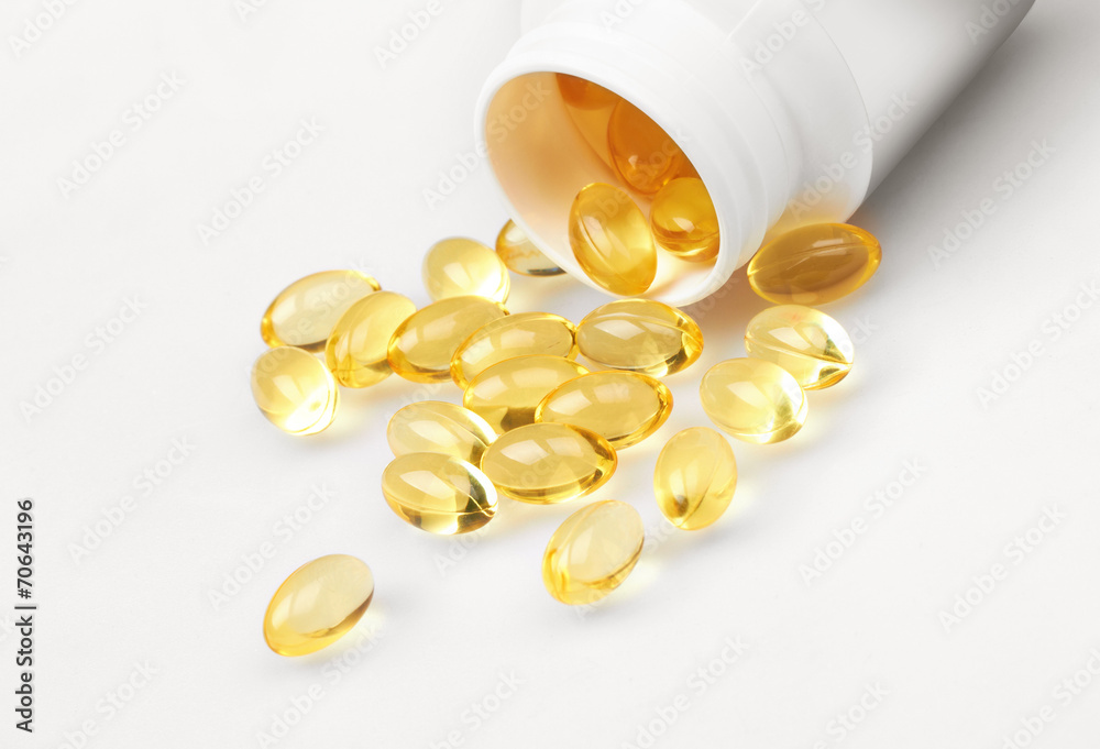 Yellow pills and pill bottle Yellow pills and pill bottle