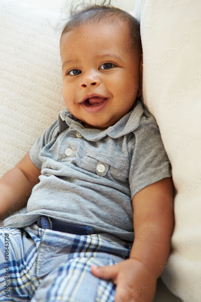 Smiling Baby Boy Lying On Back At Home Smiling Baby Boy Lying On Back At Home