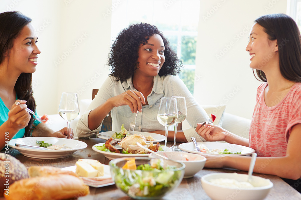 Group Of Female Friends Enjoying Meal At Home Group Of Female Friends Enjoying Meal At Home