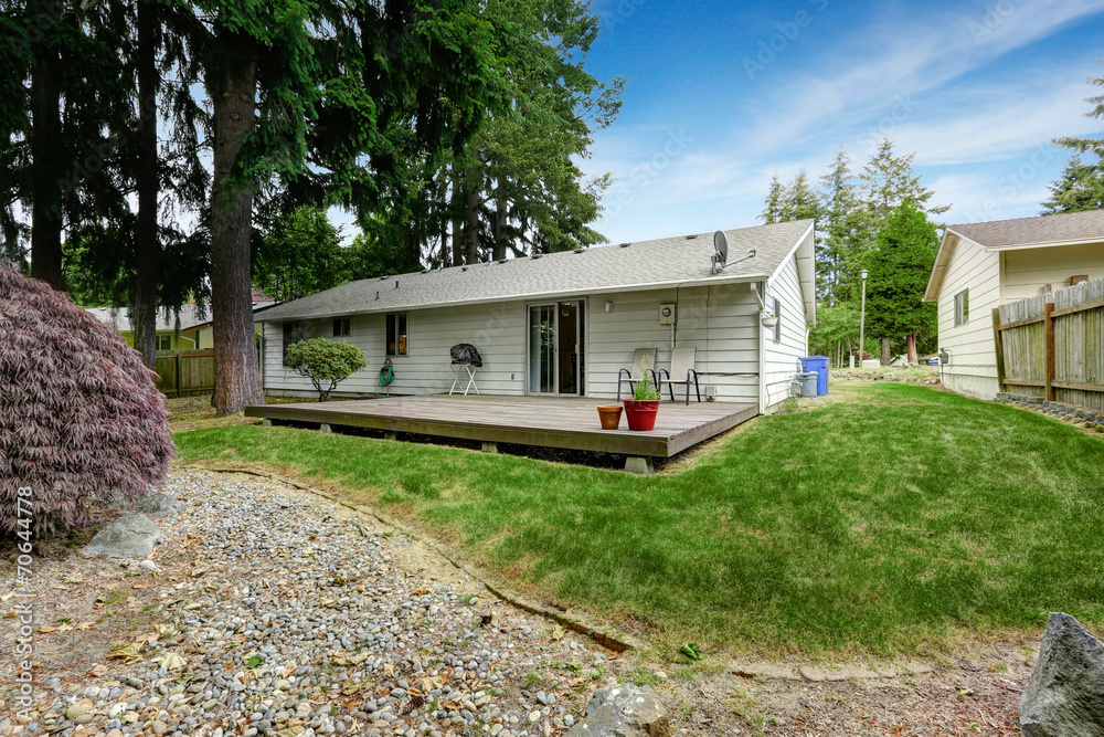 House with wooden patio area and backyard landscape House with wooden patio area and backyard landscape