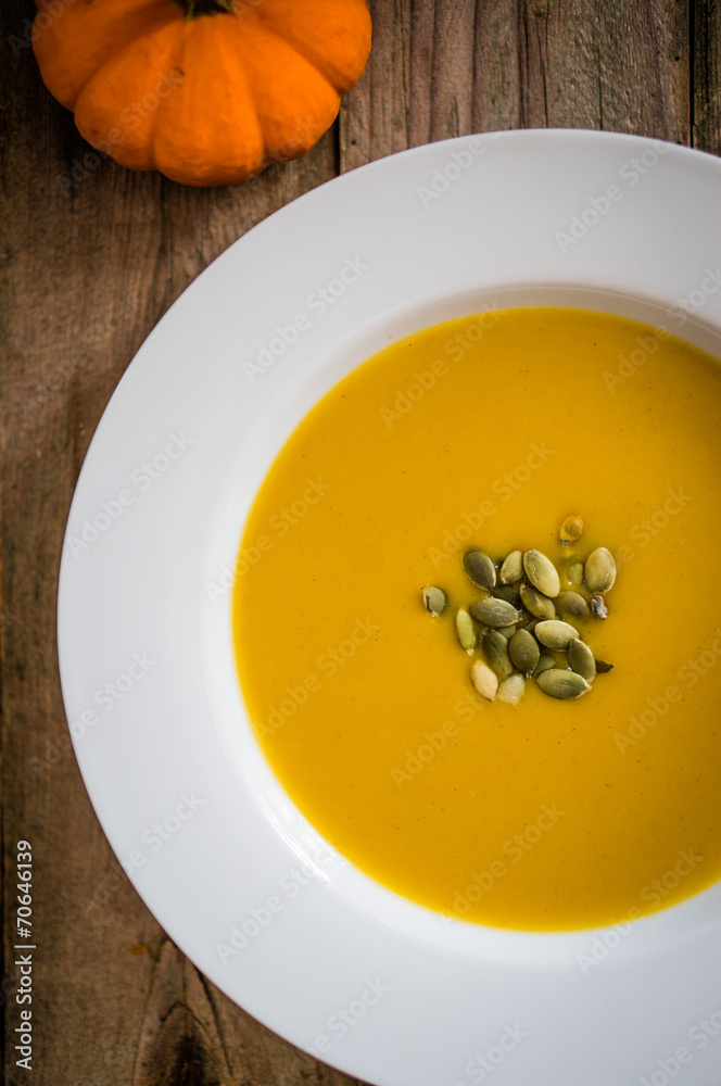 Pumpkin soup on wooden background Pumpkin soup on wooden background