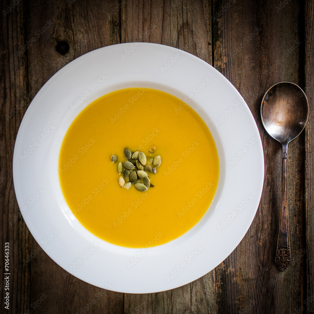 Pumpkin soup on wooden background Pumpkin soup on wooden background