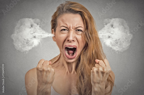  angry young woman blowing steam coming out of ears photo